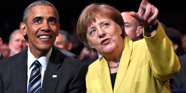 U.S. President Barack Obama, left, and German Chancellor Angela Merkel chat during the opening of the Hannover Messe industry fair in Hannover, northern Germany, Sunday, April 24, 2016. Obama is on a two-day official visit to Germany. (AP Photo/Jens Meyer)