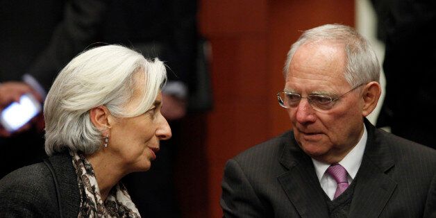 International Monetary Fund (IMF) managing director Christine Lagarde (L) and Germany's Finance Minister Wolfgang Schauble chat at the start of a Eurogroup meeting at the European Council building in Brussels, March 24, 2013. Euro zone finance ministers delayed by two hours a Sunday evening meeting intended to help Cyprus meet a Monday deadline to avert collapse of its banking system and potential exit from the euro. REUTERS/Sebastien Pirlet (BELGIUM - Tags: POLITICS BUSINESS TPX IMAGES OF THE DAY)