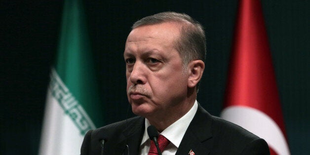 Turkey's President Recep Tayyip Erdogan listens to Iran's President Hassan Rouhani during a joint news conference in Ankara, Turkey, Saturday, April 16, 2016. Rouhani is in Turkish capital for a one-day official visit.( AP Photo/Burhan Ozbilici)