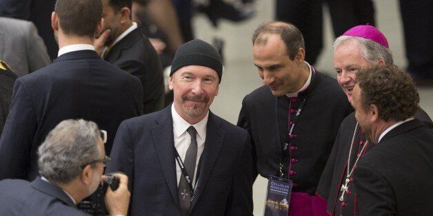 VATICAN CITY, VATICAN - APRIL 29: U2 rock band's guitarist The Edge (C) pose for a photo with some bishops before the Pope Francis receives in audience the participants at the international conference promoted by the Pontifical Council for Culture on the progress of regenerative medicine and its cultural impact, at Paul VI Audience Hall in the Vatican City, Vatican on April 29, 2016. (Photo by Riccardo De Luca/Anadolu Agency/Getty Images)
