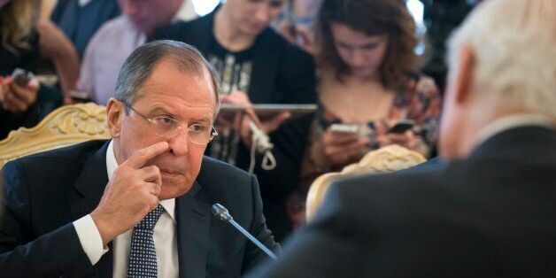 Russian Foreign Minister Sergey Lavrov, left, gestures while speaking to Staffan de Mistura, UN Special Envoy of the Secretary-General for Syria, back to a camera, during their talks in Moscow, Russia, Tuesday, May 3, 2016. Lavrov says the United States and Russia aim to create a center for rapid response to ceasefire violations in Syria. (AP Photo/Alexander Zemlianichenko)
