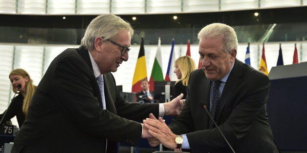 European Commission President Jean-Claude Juncker (L) shakes hands with EU Commissioner for Migration Dimitris Avramopoulos ahead of a debate over the migration deal between the EU and Turkey at the European Parliament, in Strasbourg, eastern France, on April 13, 2016. / AFP / PATRICK HERTZOG (Photo credit should read PATRICK HERTZOG/AFP/Getty Images)