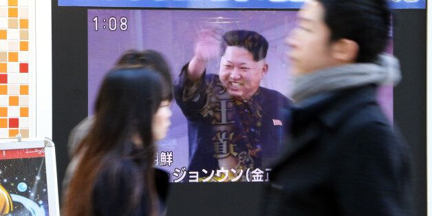 Pedestrians walk past a TV along a street in Tokyo showing North Korea's leader Kim Jong-Un (C) and a report on North Korea's rocket launch on February 7, 2016. North Korea launched a long-range rocket on February 7, violating UN resolutions and doubling down against an international community already determined to punish Pyongyang for a nuclear test last month. AFP PHOTO / Yoshikazu TSUNO / AFP / YOSHIKAZU TSUNO (Photo credit should read YOSHIKAZU TSUNO/AFP/Getty Images)