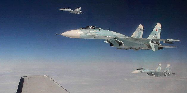 This photo made Tuesday, Aug. 27, 2013, over the Bering Strait near Alaska shows three Russian Federation Air Force SU-27s intercepting a passenger plane that was hijacked during a simulation to test the response of NORAD and Russian Federation forces. The exercise among Canadian and U.S. forces from NORAD, along with the Russian Federation, saw the Canadians successfully hand off the hijacked plane to Russian fighters over the Bering Strait. (AP Photo/Mark Thiessen)