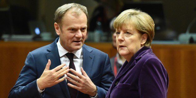 European Council president Donald Tusk (L) speaks with German Chancellor Angela Merkel before the final European Union (EU) summit of the year at the European Council in Brussels on December 17, 2015. EU leaders will discuss British Prime Minister David Cameron's controversial reform demands as well as plans for a new European border force to deal with the migration crisis. / AFP / ALAIN JOCARD (Photo credit should read ALAIN JOCARD/AFP/Getty Images)