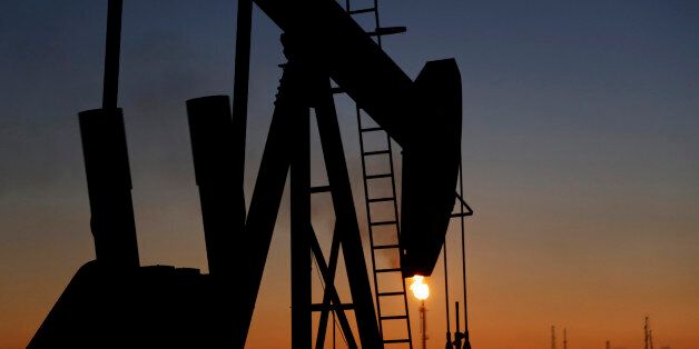 An oil pump works at sunset Monday, Jan. 18, 2016, in the desert oil fields of Sakhir, Bahrain. Iran is aiming to increase its oil production by 500,000 barrels per day now that sanctions have been lifted under a landmark nuclear deal with world powers, a top official said. (AP Photo/Hasan Jamali)