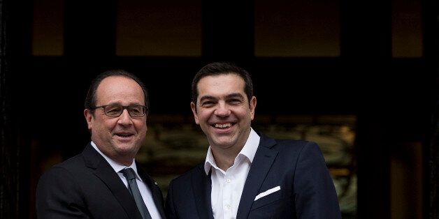 Greek Prime minister Alexis Tsipras, right, and French President Francois Hollande, pose at Maximos mansion before their meeting in Athens, Friday, Oct. 23, 2015. Hollande called Thursday for talks relieving Greece's crushing debt load and spurring investment, measures that could help the country recover as it imposes harsh austerity measures demanded by international creditors.(AP Photo/Petros Giannakouris)