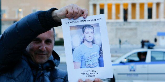 SYNTAGMA SQUARE, ATHENS, ATTICA, GREECE - 2015/03/16: A man holds up a poster with a picture of Vangelis Giakoumakis that reads 'Vangelis is my child - No to violence, indifference, silence'. A vigil was held for dead student Vangelis Giakoumakis in Syntagma Square in Athens. Giakoumakis, a alleged bullying victim was found dead from alleged suicide near the Greek city of Ioannina, after he vanished around a month ago. (Photo by Michael Debets/Pacific Press/LightRocket via Getty Images)