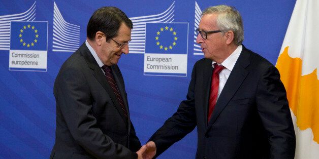 European Commission President Jean-Claude Juncker, right, greets Cypriot President Nicos Anastasiades prior to a meeting at EU headquarters in Brussels on Wednesday, March 16, 2016. The Cypriot president is in Brussels on Wednesday to meet with EU leaders prior to a summit on migration which begins Thursday. (AP Photo/Virginia Mayo)