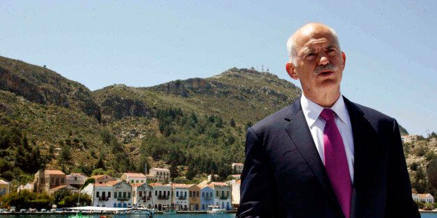 FILE - In this file photo of Friday, April 23, 2010 Greek Prime Minister George Papandreou announces Greece's decision to request activation of a joint eurozone-International Monetary Fund financial rescue plan, from the main port of the remote southeast Greek Aegean island of Kastellorizo. It's an anniversary few are celebrating. A year ago Saturday, with its faltering economy days away from bankruptcy, Greece ended months of speculation and requested bailout loans. Papandreou chose the remote island of Kastelorizo, and its tranquil seaside backdrop, to announce the