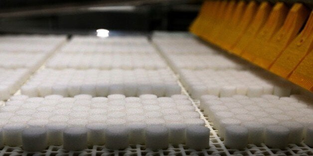 TO GO WITH AFP STORY BY EMMANUELLE MICHEL Sugar cubes come off an assembly line on November 26, 2014 at the Crystal Union Group in Bazancourt, near the eastern city of Reims. The refinery, one of the largest in France, works night and day since the begining of the beet harvest. The plant transforms 22,000 tons of beets into 1,600 tons of sugar a day. AFP PHOTO / FRANCOIS NASCIMBENI (Photo credit should read FRANCOIS NASCIMBENI/AFP/Getty Images)