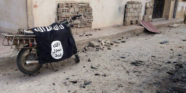 A flag belonging to the Islamic State fighters is seen on a motorbike after forces loyal to Syria's President Bashar al-Assad recaptured the historic city of Palmyra, in Homs Governorate in this handout picture provided by SANA on March 27, 2016. REUTERS/SANA/Handout via Reuters ATTENTION EDITORS - THIS PICTURE WAS PROVIDED BY A THIRD PARTY. REUTERS IS UNABLE TO INDEPENDENTLY VERIFY THE AUTHENTICITY, CONTENT, LOCATION OR DATE OF THIS IMAGE. EDITORIAL USE ONLY. NOT FOR SALE FOR MARKETING OR ADVERTISING CAMPAIGNS. THIS PICTURE IS DISTRIBUTED EXACTLY AS RECEIVED BY REUTERS, AS A SERVICE TO CLIENTS.