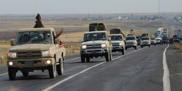 A convoy of peshmerga vehicles makes its way to the Turkish-Syrian border, near the town of Kiziltepe, in the southeastern Mardin province October 29, 2014. Iraqi peshmerga fighters arrived in southeastern Turkey on Wednesday en route for the Syrian town of Kobani to try to help fellow Kurds break an Islamic State siege which has defied U.S.-led air strikes. Kobani, nestled on the border with Turkey, has been under assault from Islamic State militants for more than a month and its fate has become a key test of the U.S.-led coalition's ability to combat the Sunni insurgents. REUTERS/Stringer (TURKEY - Tags: POLITICS MILITARY CONFLICT TPX IMAGES OF THE DAY)