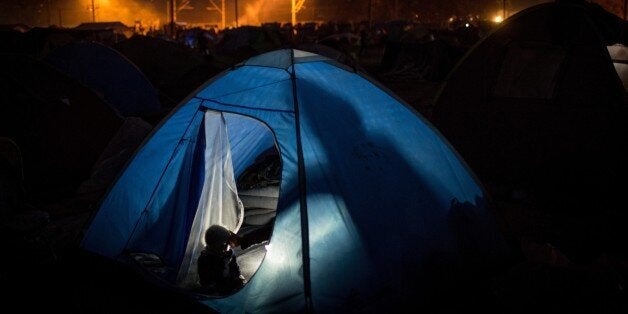 IDOMENI, GREECE - APRIL 14: Refugees wait at the makeshift refugee camp near at the Macedonian border on the Greek side in Idomeni, Greece on April 14, 2016. Refugees' 'journey of hope' towards Western European countries where they dream of having a better life ends in the Balkans following the latest decision. (Photo by Andrei Pungovschi/Anadolu Agency/Getty Images)