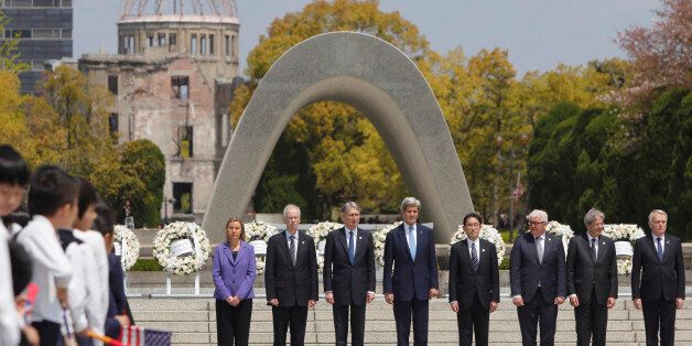 G7 foreign ministers, from left, E.U. High Representative for Foreign Affairs Federica Mogherini, Canada's Foreign Minister Stephane Dion, Britain's Foreign Minister Philip Hammond, U.S. Secretary of State John Kerry, Japan's Foreign Minister Fumio Kishida, Germany's Foreign Minister Frank-Walter Steinmeier, Italy's Foreign Minister Paolo Gentiloni and France's Foreign Minister Jean-Marc Ayrault stand together after placing wreaths at the cenotaph at Hiroshima Peace Memorial Park in Hiroshima, western Japan, Monday, April 11, 2016. (Jonathan Ernst/Pool Photo via AP)