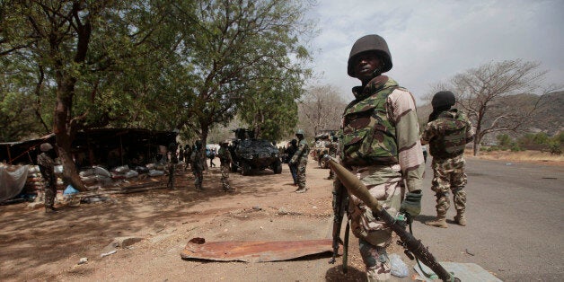 FILE - In this Wednesday April 8, 2015 file photo, Nigerian soldiers man a checkpoint in Gwoza, Nigeria, a town newly liberated from Boko Haram. Nigeriaâs president has exaggerated the militaryâs success against Boko Haram, say officials in northern Nigeria in response to an American commanderâs testimony that the Islamic extremist group still holds territory. (AP Photo/Lekan Oyekanmi, File)