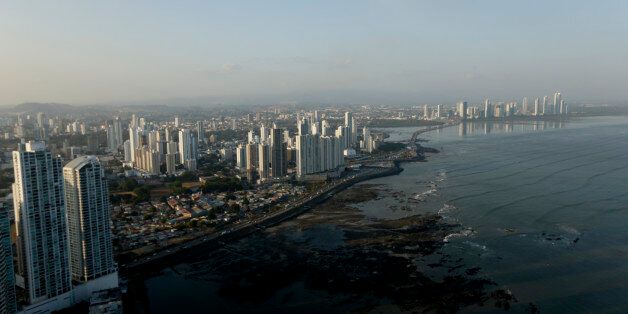 The setting sun lights up the Panama City skyline, Monday, April 4, 2016. Panama's President Juan Carlos Varelasays says his government will cooperate