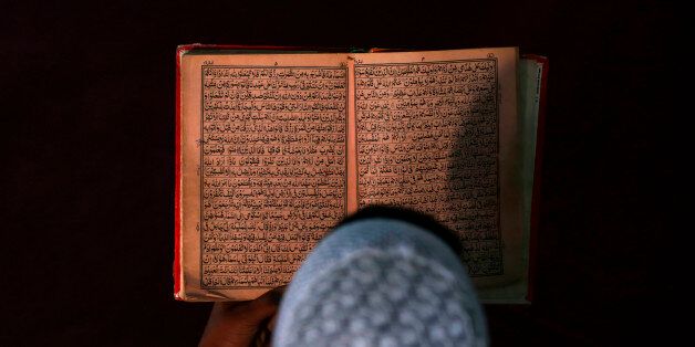 An Afghan boy reads the Koran in a madrasa, or religious school, during the Muslim holy month of Ramadan in Kabul June 30, 2014. REUTERS/Mohammad Ismail (AFGHANISTAN - Tags: RELIGION TPX IMAGES OF THE DAY EDUCATION SOCIETY)