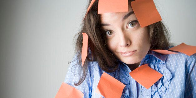Portrait of a young woman covered with adhesive notes
