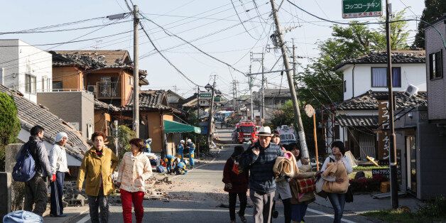 KUMAMOTO, JAPAN - APRIL 16: Local residents evacuate from the town centre on April 16, 2016 in Kumamoto, Japan. Following a 6.4 magnitude earthquake on April 14th, the Kumamoto prefecture was once again struck by a 7.3 magnitude earthquake, killing 9 people. (Photo by Taro Karibe/Getty Images)