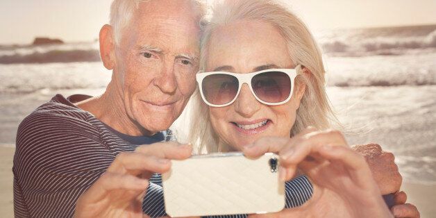 Senior couple taking self-portrait with phone