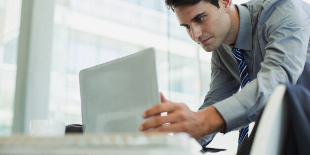 Businessman using laptop in office