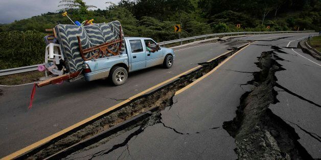 A truck moves the belongings of a family from Pedernales, over the earthquake destroyed road to Jama, in Ecuador, Monday, April 18, 2016. A Saturday night quake left a trail of ruin along Ecuadorâs Pacific Ocean coast. Hundreds have died, thousands are homeless and without electricity. (AP Photo/Dolores Ochoa)