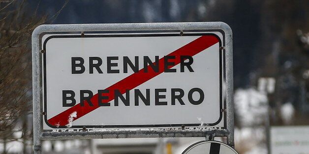Cars drive along a street with a sign reading 'Brenner-Brennero' in the Italian village of Brenner on the Italian-Austrian border, March 3, 2016. REUTERS/Dominic Ebenbichler