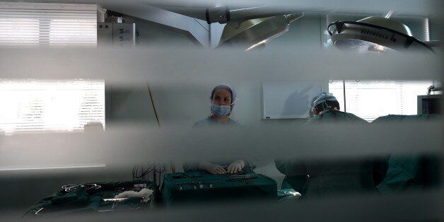 TO GO WITH AFP STORY BY JOHN HADOULIS AND ELLA IDE A nurse stands in a surgery room in an Athens hospital on July 8, 2015. With expectations of a Greek exit from the eurozone gathering pace, health officials are worried that medicine and other vital supplies will soon be disrupted, with potentially deadly results. AFP PHOTO / ARIS MESSINIS (Photo credit should read ARIS MESSINIS/AFP/Getty Images)