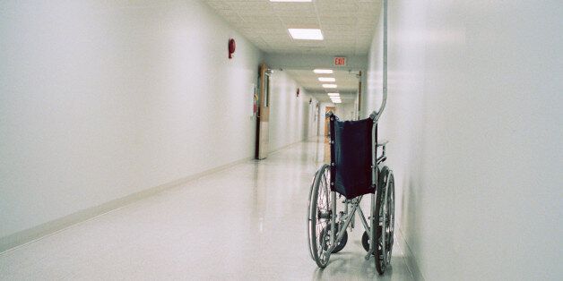 Collapsible wheelchair in empty corridor of hospital
