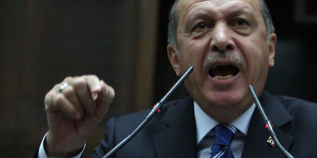 Turkish Prime Minister Recep Tayyip Erdogan addresses his supporters at the parliament in Ankara, Turkey, Tuesday, April 29, 2014. Erdogan rejected human rights criticism by German President Joachim Gauck, saying Germany ought to save its comments for its own troubles at home, such as racist attacks on Turks in Germany.