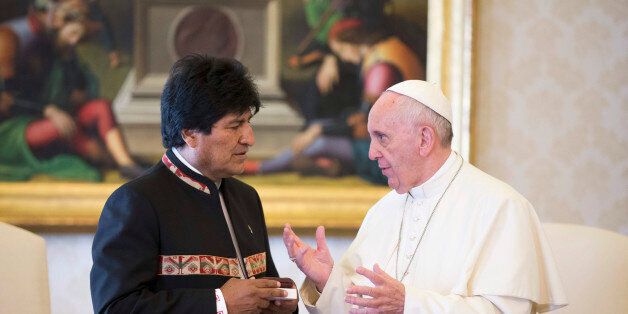 Bolivia's President Evo Morales, left, and Pope Francis share a word on the occasion of their private meeting in the Apostolic Palace at the Vatican, Friday, April 15, 2016. (AP Photo/Alessandra Tarantino, pool)