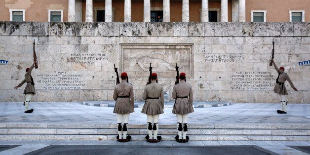 Presidential guards perform ceremonial duties at the Tomb of the Unknown Soldier outside the Greek parliament at Syntagma square in Athens, Greece, on Thursday, Sept. 17, 2015. Greece's unemployment rate in the second quarter fell to 24.6 percent from 26.6 percent in the previous three months ahead of the summer tourist season, the Hellenic Statistical Authority said Thursday. Photographer: Yorgos Karahalis/Bloomberg via Getty Images