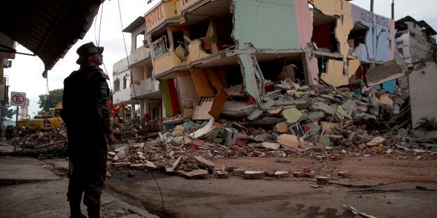 An air force soldier stands guard in front of buildings collapsed by an earthquake in Manta, Ecuador, Monday, April 18, 2016. A Saturday night quake left a trail of ruin along Ecuadorâs Pacific Ocean coast. Hundreds died and thousands are homeless. (AP Photo/Rodrigo Abd)