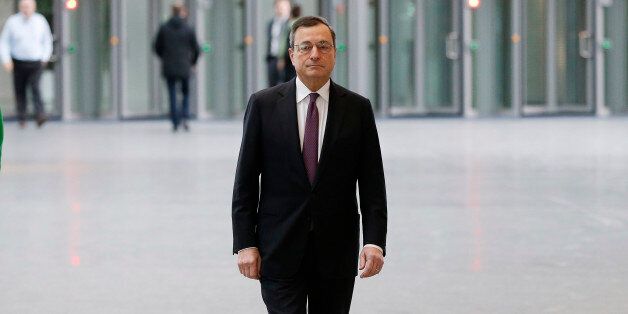 FILE - In this Jan. 19, 2016 file photo Mario Draghi, President of the European Central Bank Mario Draghi, walks in the lobby of the ECB headquarters in Frankfurt, Germany. (AP Photo/Michael Probst, file)