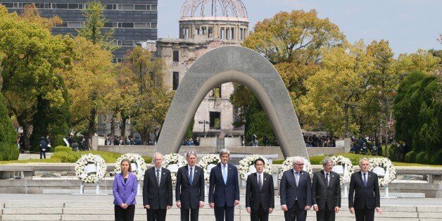 HIROSHIMA, JAPAN - APRIL 11: Japanese Foreign Minister Fumio Kishida (4th R), US Secretary of State John Kerry (4th L), European Union's High Representative for Foreign Affairs Federica Mogherini (L), Canadian Foreign Minister Stephane Dion (2nd L), British Foreign Minister Philip Hammond (3rd L), Italian Foreign Minister Paolo Gentiloni (2nd R), French Foreign Minister Jean-Marc Ayrault (R) and German Foreign Minister Frank-Walter Steinmeier (3rd R) pose for a family photo in front of Memorial Cenotaph at the Hiroshima Peace Memorial Park in Hiroshima, Japan on April 11, 2016. (Photo by Foreign Ministry of Japan / Handout/Anadolu Agency/Getty Images)