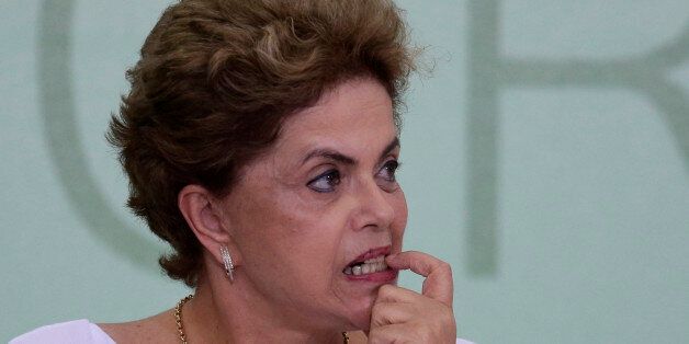 Brazil's President Dilma Rousseff bites on her fingernail during a signing ceremony for land reform agreements, at the Planalto Presidential Palace, in Brasilia, Brazil, Friday, April 1, 2016. Rousseff, who is battling the biggest recession in decades and a corruption probe that has circled in on members of her inner circle, is facing impeachment proceedings in Congress on allegations she violated fiscal laws. (AP Photo/Eraldo Peres)