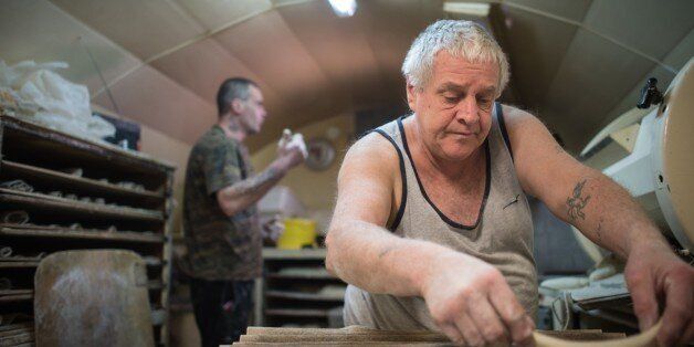 Michel Flamant (R) and Jerome (L) work in their bakery on March 23, 2016, in Dole, eastern France.Michel Flamant, the owner of the bakery decided to teach baking and pastry to Jerome and to sell him his bakery for one symbolic euro, after Jerome saved his life. / AFP / SEBASTIEN BOZON (Photo credit should read SEBASTIEN BOZON/AFP/Getty Images)