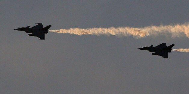Rafale fighter jets dump fuel after a mission, before landing on France's flagship Charles de Gaulle aircraft carrier in the Persian Gulf, Tuesday, Jan. 12, 2016. The Charles de Gaulle joined the U.S.- led coalition against Islamic State in November, as France intensified its airstrikes against extremist sites in Syria and Iraq in response to IS threats against French targets. (AP Photo/Christophe Ena)