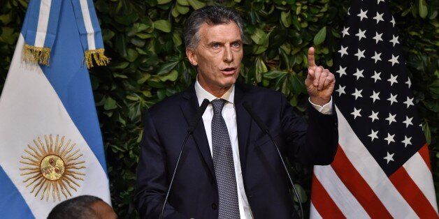 Argentine President Mauricio Macri speaks at a state dinner in honour of US President Barack Obama (L) at the Kirchner Cultural Centre in Buenos Aires on March 23, 2016. The United States and Argentina sealed a major trade deal on the eve -the first day of President Barack Obama's visit- bolstering the efforts of his counterpart to end a decade-and-a-half of international financial isolation. AFP PHOTO / NICHOLAS KAMM / AFP / NICHOLAS KAMM (Photo credit should read NICHOLAS KAMM/AFP/Get