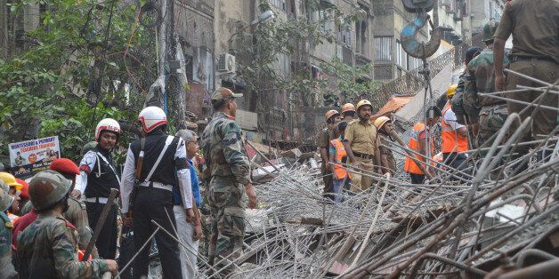 KOLKATA, WEST BENGAL, INDIA - 2016/03/31: An under-construction flyover collapsed in a congested Kolkata neighborhood, killing at least 22 people and trapping hundreds underneath giant steel frames and concrete slabs. Around 250 meters of the 2.2 kilometer-long Vivekananda Road flyover crashed into dense traffic around 12.30 am near one of Kolkatas most important business districts, Burrabazar. Experts warned that the toll will mount and clearing debris may take several days as cranes to lift heavy concrete slabs hadnt arrived hours after the accident. Rescuers pulled out 80 people by 6pm. (Photo by Tanmoy Bhaduri/Pacific Press/LightRocket via Getty Images)
