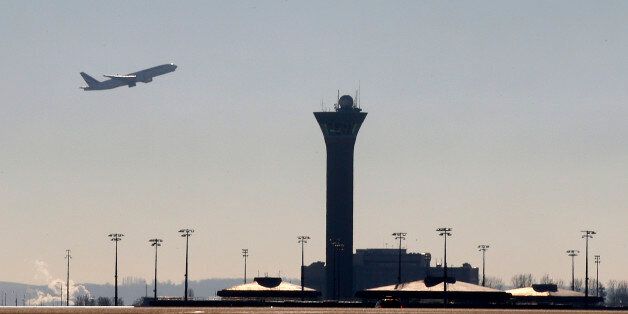 An airplane takes-off past a control tower at the Charles-de-Gaulle airport in Roissy on the eve of an air traffic controller's strike, near Paris, France, January 25, 2016. REUTERS/Jacky Naegelen