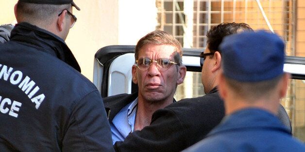 Seif al-Din Mohamed Mostafa, an Egytpian man who hijacked an EgyptAir passenger plane the previous day and forced it to divert to Cyprus demanding to see his ex-wife, is surrounded by policeman as he arrives at the court in Larnaca on March 30, 2016.The six-hour airport standoff ended peacefully. The hijacker, described by officials as 'unstable', had claimed to be wearing a bomb belt but no explosives were discovered after he gave himself up at Larnaca airport and was arrested. / AFP / GEORGE MICHAEL (Photo credit should read GEORGE MICHAEL/AFP/Getty Images)