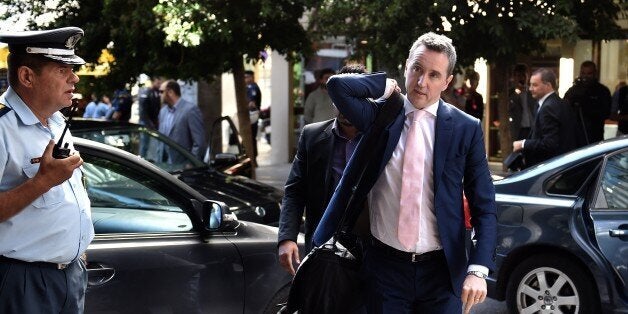 European Commission Director-General for Economic and Monetary Affairs, Declan Costello arrives at the Finance ministry in Athens on September 30, 2014. Greece's massive debt crisis nearly broke apart the eurozone. But after four years and a bailout worth up to 240 billion euros ($300 billion), Athens has largely repaired its finances and is eager to get free from the EU and IMF's tight budgetary and policy leash. AFP PHOTO / ARIS MESSINIS (Photo credit should read ARIS MESSINIS/AFP/Getty Images)