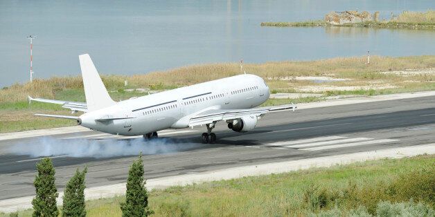 Passenger airplane landing to runway, city of Kerkira, Corfu island, Greece