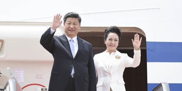 HARARE, Dec. 1, 2015 -- Chinese President Xi Jinping and his wife Peng Liyuan wave upon their arrival in Harare, Zimbabwe, on Dec. 1, 2015. Xi arrived here Tuesday for a state visit to Zimbabwe. (Xinhua/Xie Huanchi via Getty Images)