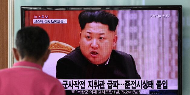 A man looks at a television screen showing an image of Kim Jong Un, leader of North Korea, during a news broadcast on North Korea's exchange of fire with South Korea at Seoul Station in Seoul, South Korea, on Friday, Aug. 21, 2015. North Korean leader Kim Jong Un ordered his army to prepare for war after an exchange of fire with South Korea, ratcheting up the rhetoric as the latest skirmish between the two nations intensifies. Photographer: SeongJoon Cho/Bloomberg via Getty Images