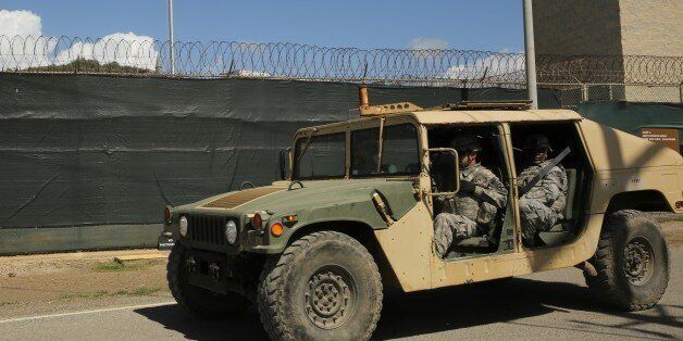 In this Feb. 2, 2016 photo, military personnel patrol outside Camp 6 at Guantanamo Bay, Cuba. After 14 years, the detention center appears to be winding down despite opposition in Congress to President Barack Obamaâs intent to close the facility and confine the remaining prisoners someplace else. (AP Photo/Ben Fox)