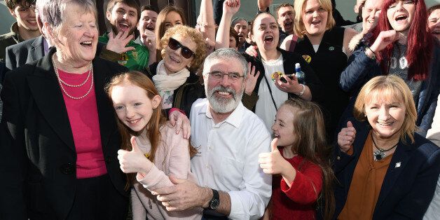 DUNDALK, IRELAND - FEBRUARY 28: Sinn Fein's Gerry Adams (C) celebrates with supporters after Adams was re-elected to government at the Irish General Election constituency count on February 28, 2016 in Dundalk, Ireland. Munster is expected to be elected later this afternoon, she will be the first female TD elected in Louth. The Fine Gael and Labour coalition suffered heavy losses, falling well short of the numbers needed to form a majority government. Fianna Fail and Sinn Fein have made significant gains with fresh elections already mooted with the prospect of a hung parliament. (Photo by Charles McQuillan/Getty Images)