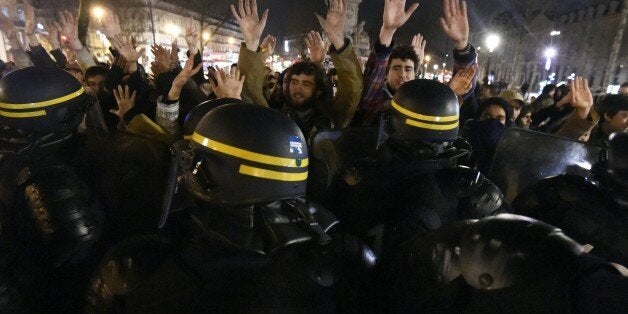 Militants of the 'Nuit debout' movement face riot police forces at the Place de la Republique in Paris on April 3, 2016, as they plan to spend the night camped out to protest against the government's planned labour reform and against forced evictions. / AFP / DOMINIQUE FAGET (Photo credit should read DOMINIQUE FAGET/AFP/Getty Images)